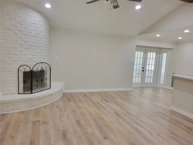 a view of a livingroom with wooden floor and a window