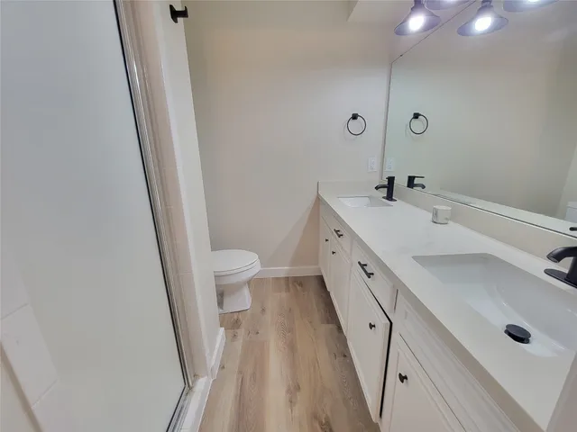 a bathroom with a double vanity sink and a mirror