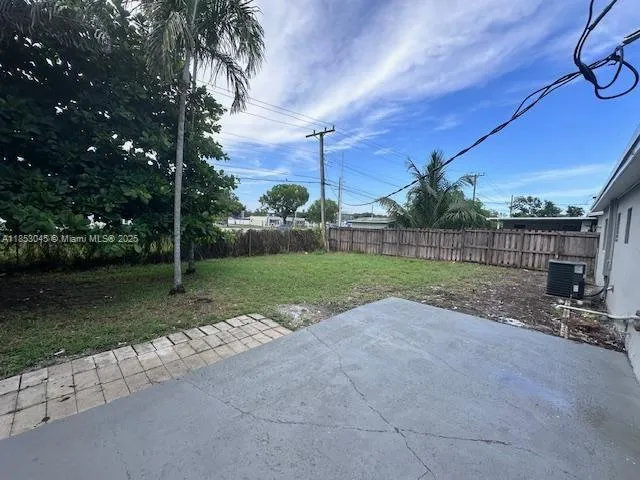 a view of a yard with basketball court