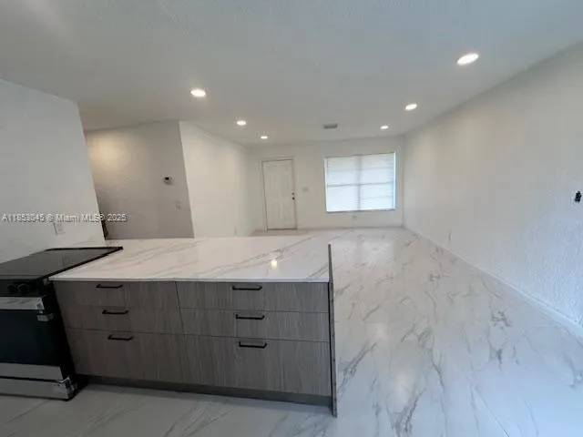 a view of a kitchen with a sink dishwasher and a refrigerator