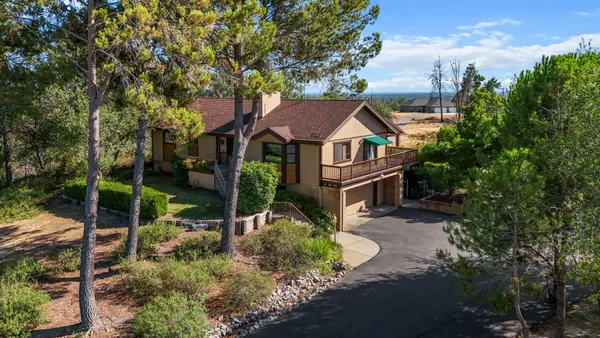 an aerial view of a house with swimming pool garden and patio