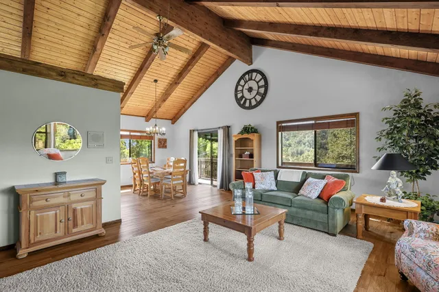 a dining room with furniture a chandelier and wooden floor