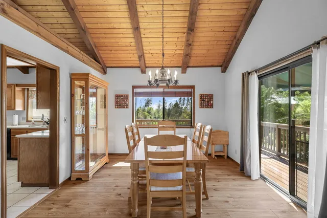 a kitchen with a table chairs refrigerator and cabinets
