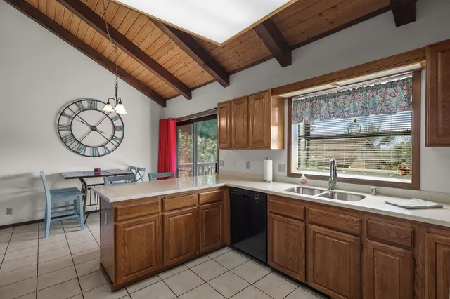 a bedroom with two beds and a chandelier