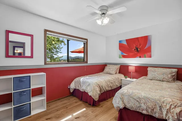 a bedroom with a large bed and a chandelier
