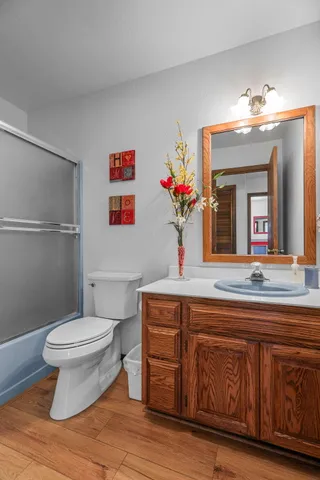 a bedroom with a large bed a chandelier and a window