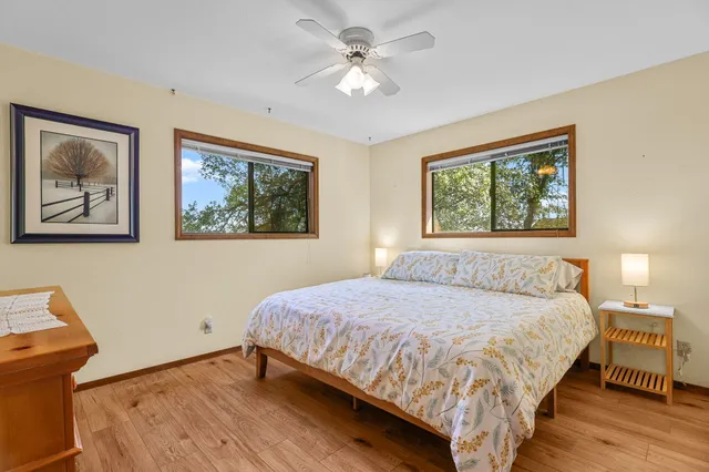 a bedroom with a large bed and a chandelier