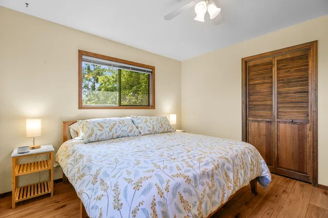 a bedroom with a large bed and a chandelier