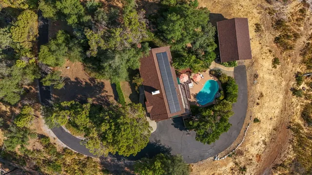 a front view of a house with a yard and mountain view