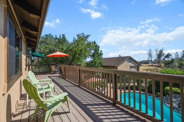 a kitchen with stainless steel appliances kitchen island granite countertop a table chairs and a refrigerator