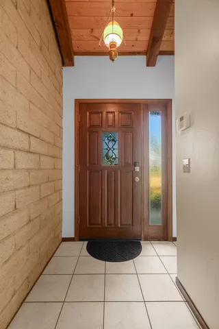 a view of a dining room with furniture large windows and wooden floor