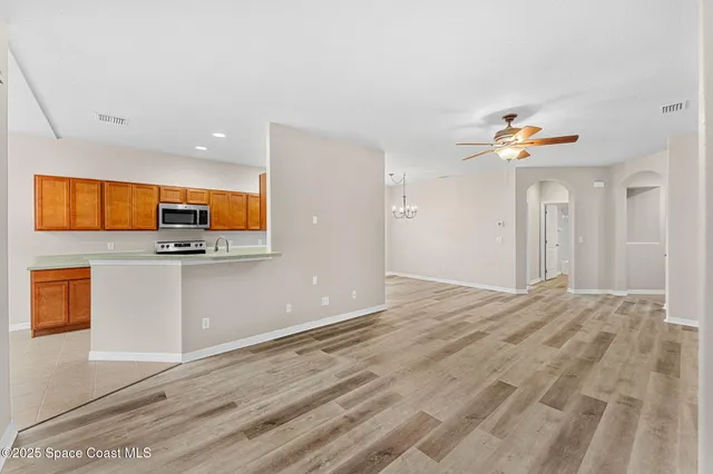 a view of a room with wooden floor