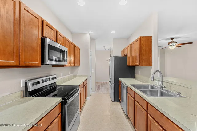 a view of a livingroom with a ceiling fan and window