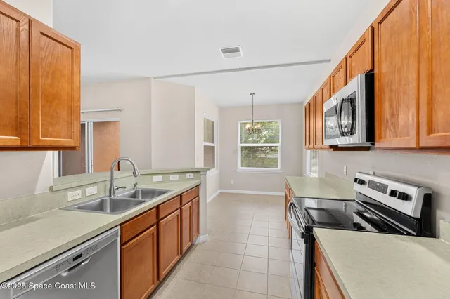 a kitchen with a sink a stove and cabinets