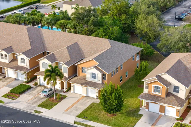 an aerial view of multiple houses with yard