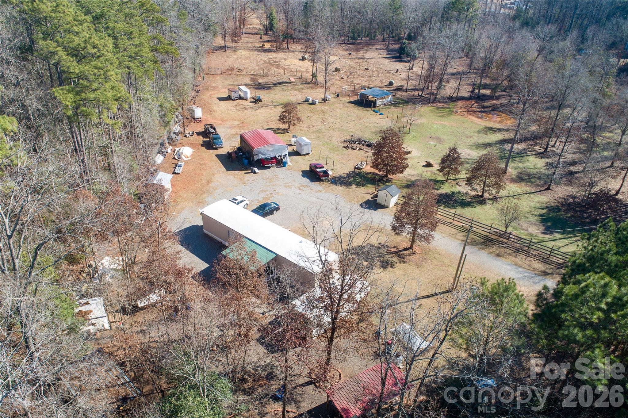 a aerial view of a house with a yard and lake view