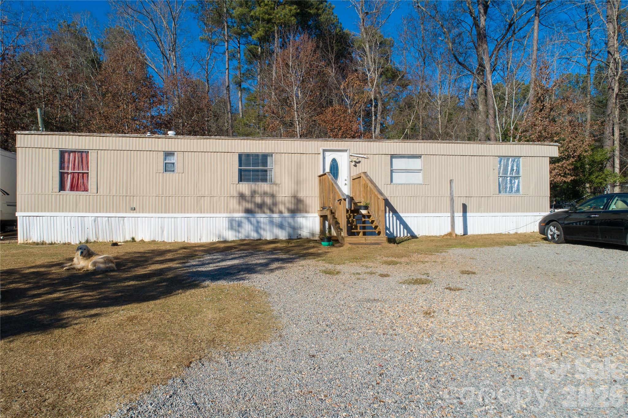 153 Lake Road Rockingham, NC 28379 - Photo 17 of 30 a view of a house with backyard and a tree