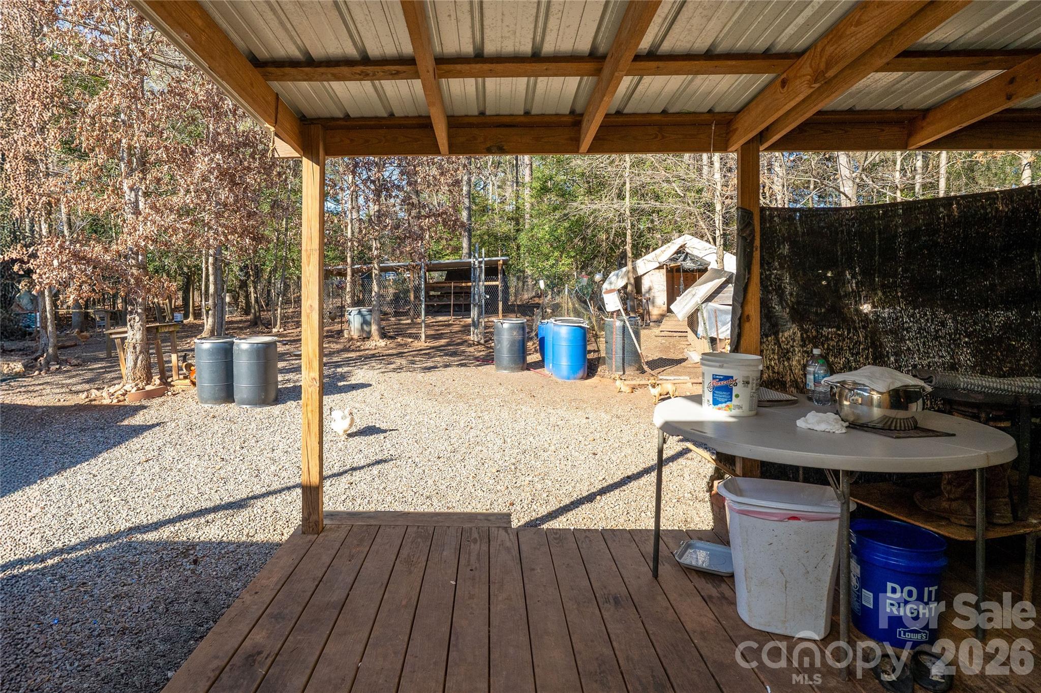 153 Lake Road Rockingham, NC 28379 - Photo 21 of 30 a view of a patio with table and chairs potted plants with wooden floor