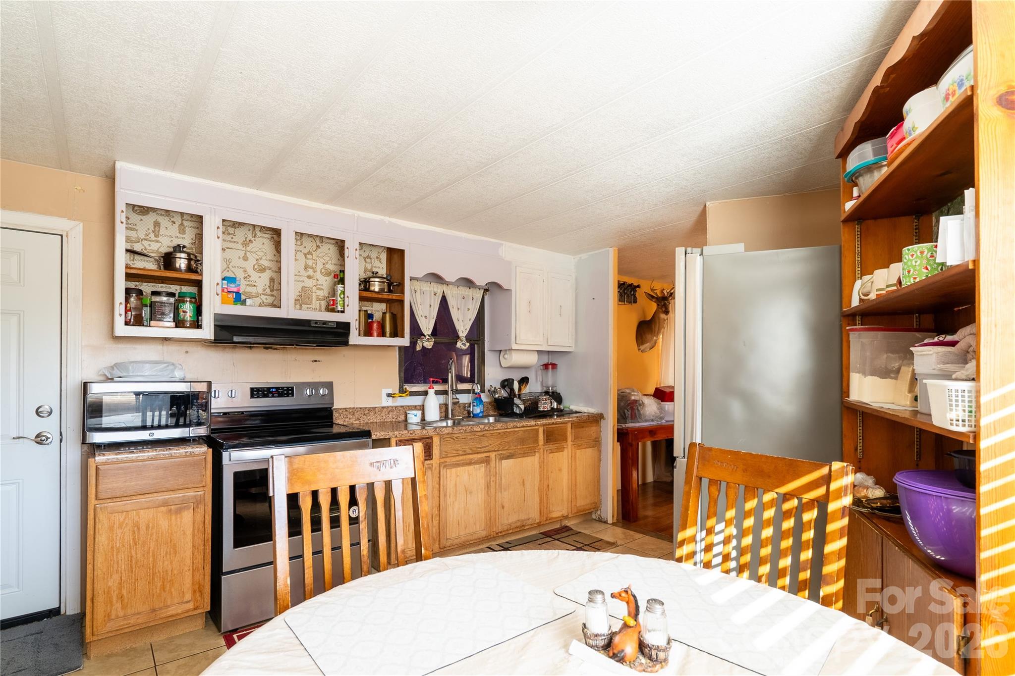 153 Lake Road Rockingham, NC 28379 - Photo 24 of 30 a kitchen with stainless steel appliances granite countertop a stove top oven a sink a dining table and chairs with wooden floor