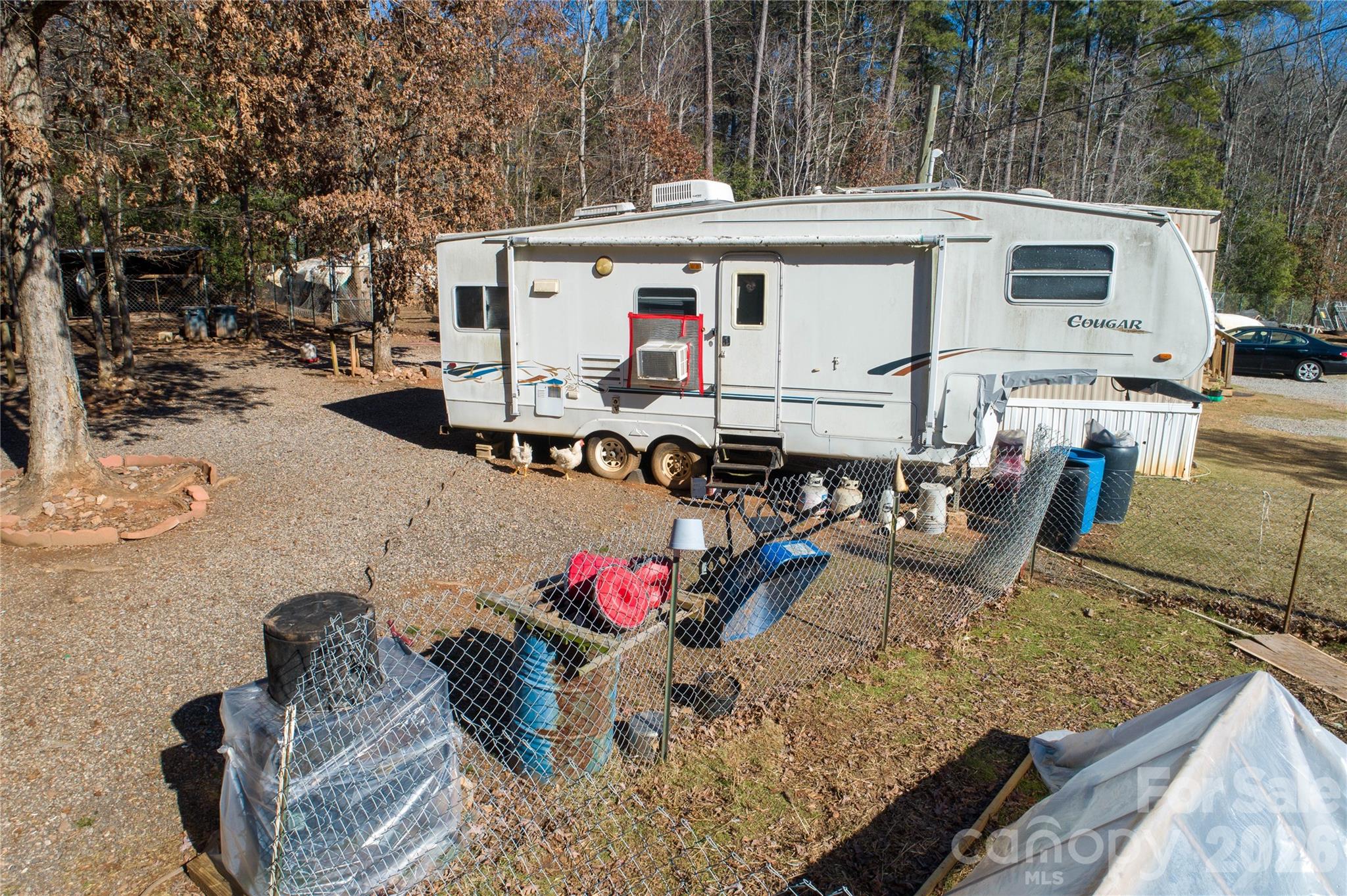 153 Lake Road Rockingham, NC 28379 - Photo 9 of 30 a view of a patio with table and chairs potted plants