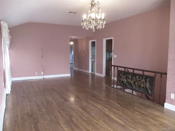 a view of a chandelier and wooden floor