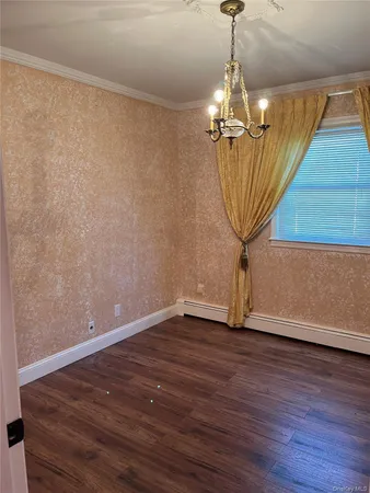 a view of a room with wooden floor chandelier and entryway