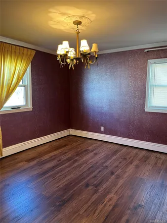 a view of room with window and chandelier