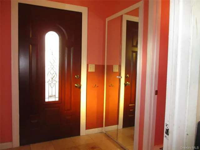 a view of a hallway with windows and a bathroom
