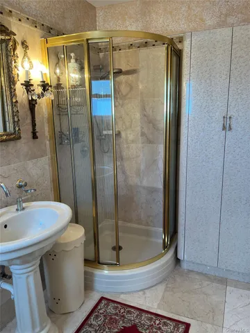 a bathroom with a shower and a sink