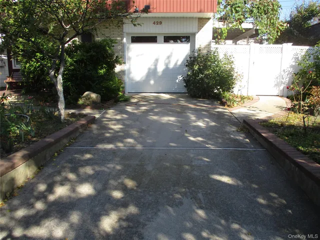 a view of a house with a tree in the background
