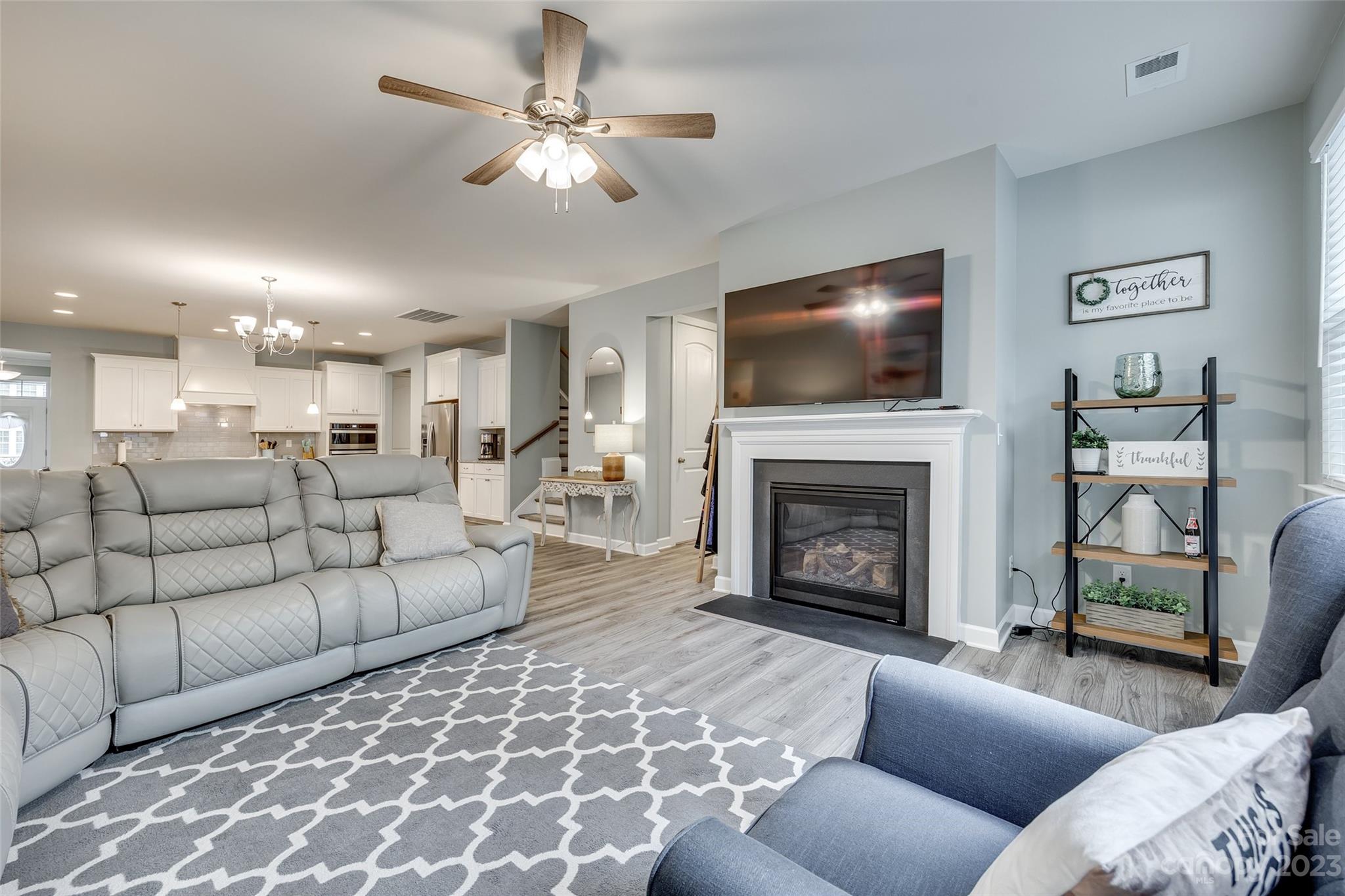 439 Sandbar Point Clover, SC 29710 - Photo 14 of 36 a living room with furniture a flat screen tv and a fireplace