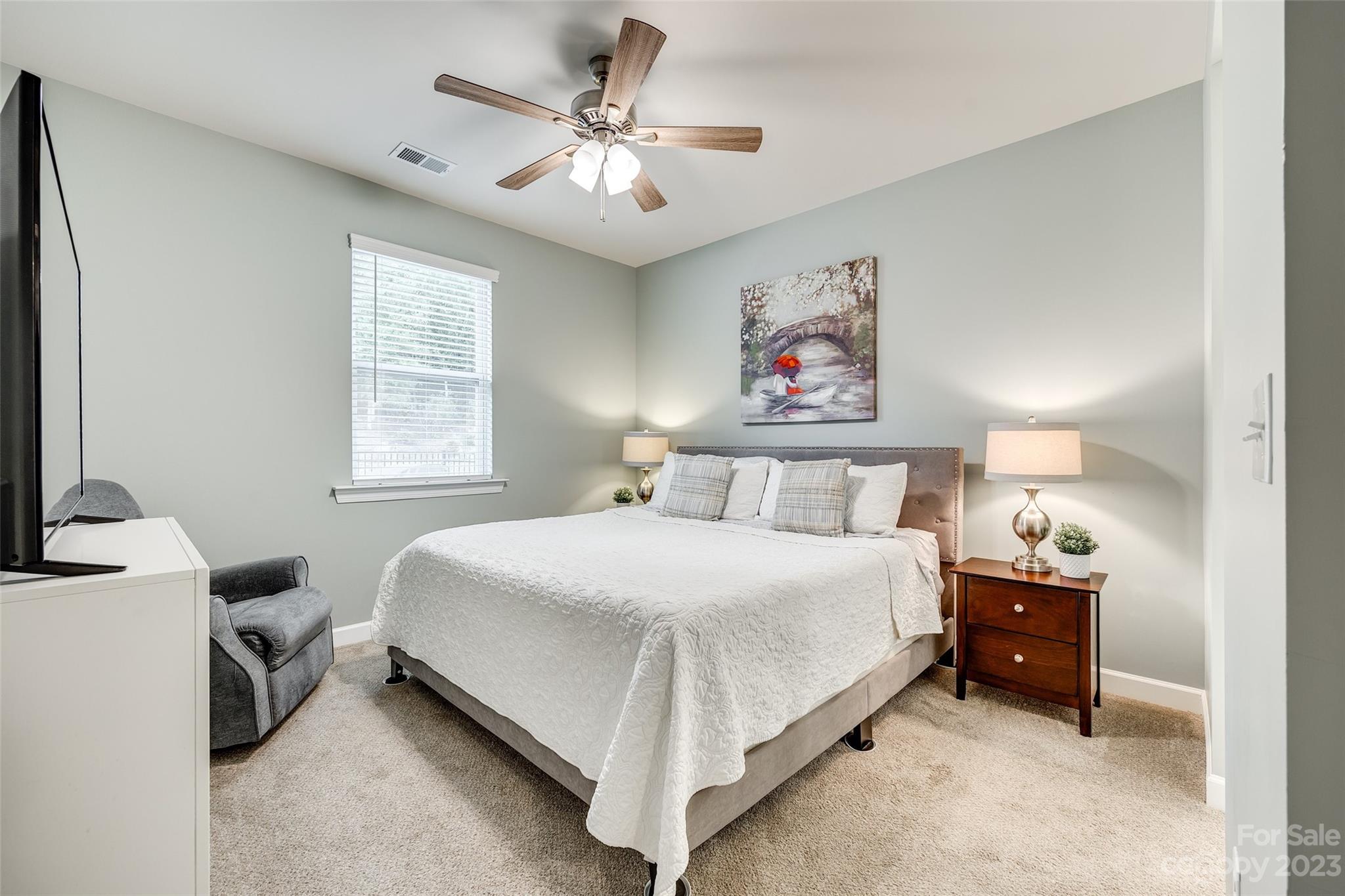 439 Sandbar Point Clover, SC 29710 - Photo 20 of 36 a bedroom with a bed and a chandelier