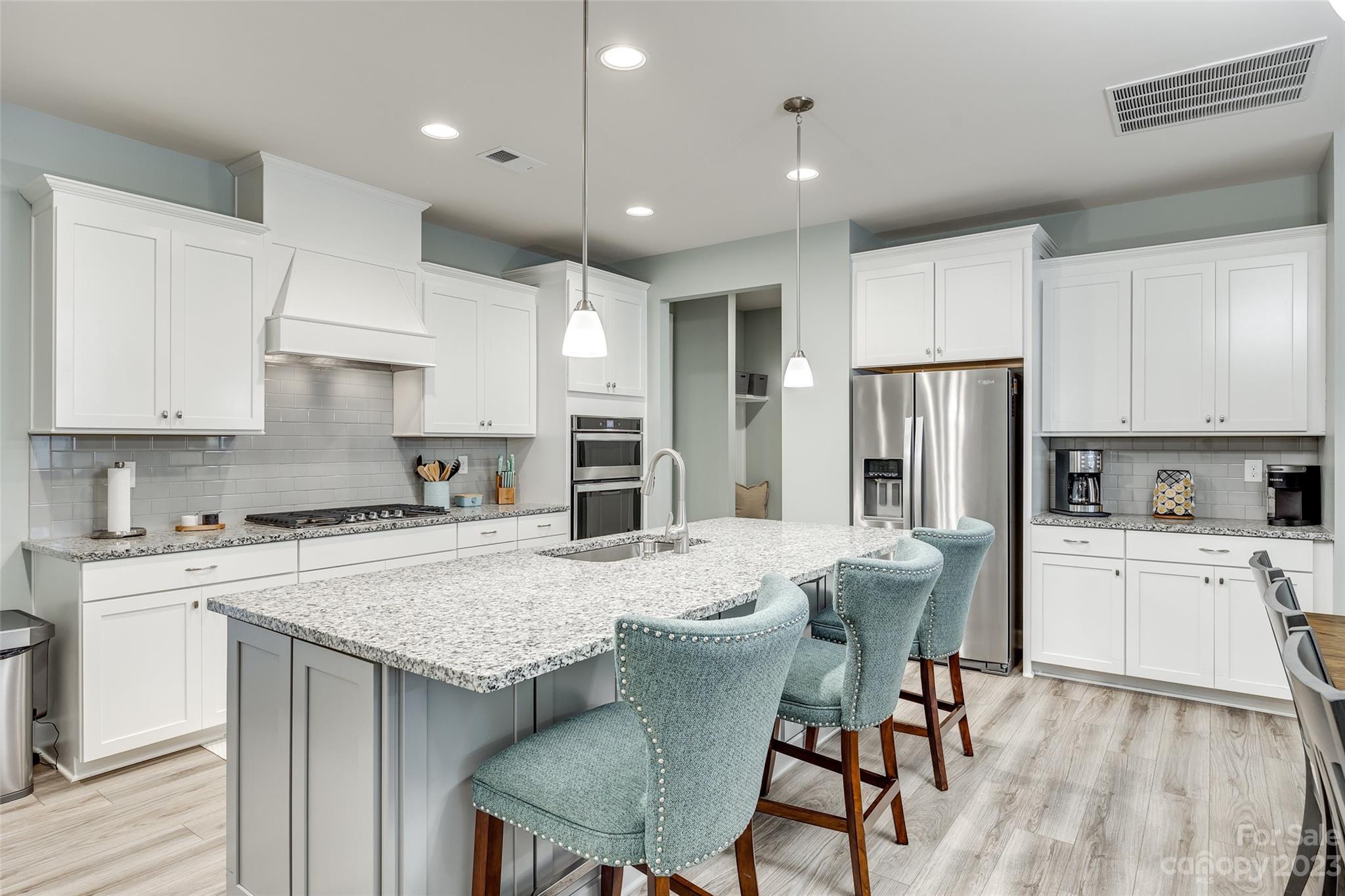 439 Sandbar Point Clover, SC 29710 - Photo 8 of 36 a kitchen with refrigerator a stove and chairs