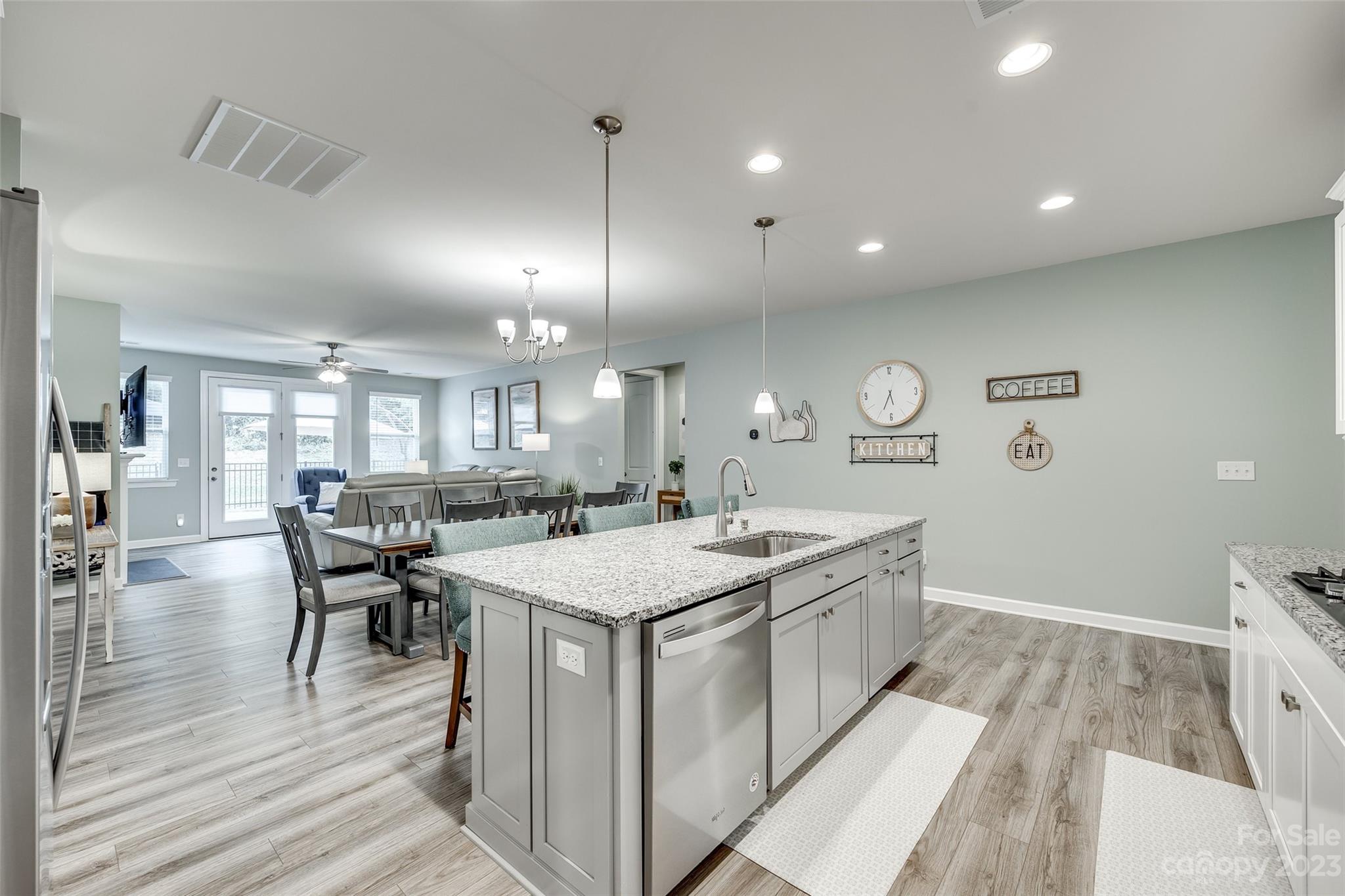 439 Sandbar Point Clover, SC 29710 - Photo 9 of 36 a large kitchen with kitchen island a island a sink a stove and wooden floor