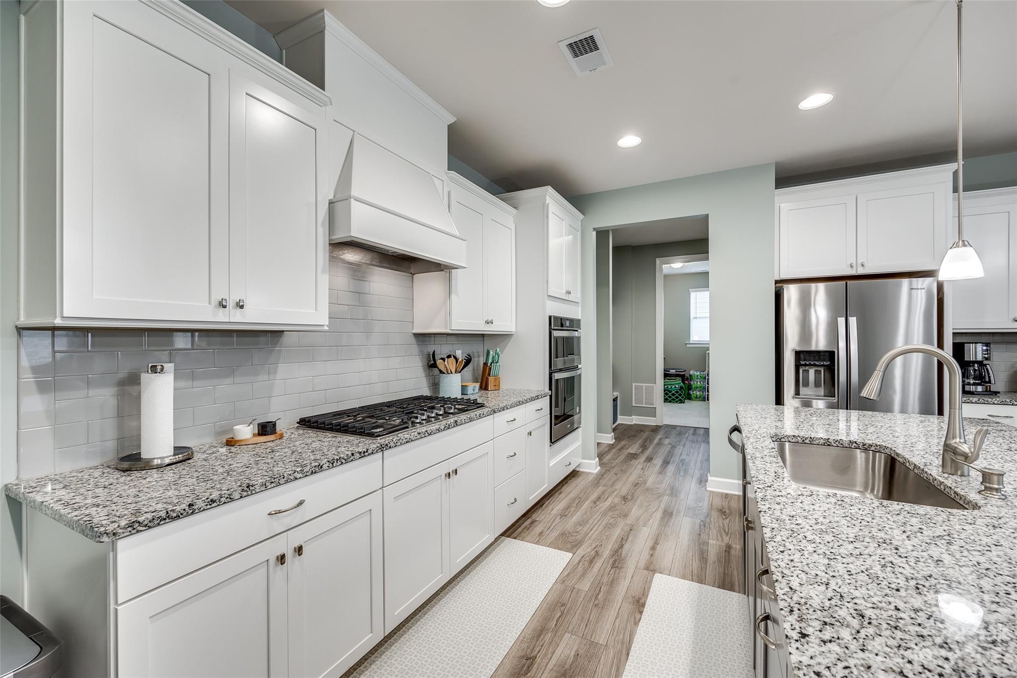 439 Sandbar Point Clover, SC 29710 - Photo 10 of 36 a large kitchen with stainless steel appliances granite countertop a lot of counter space and wooden floors