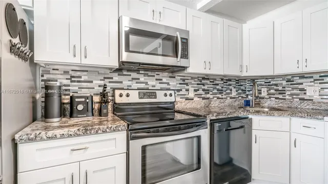 a stove top oven sitting inside of a kitchen