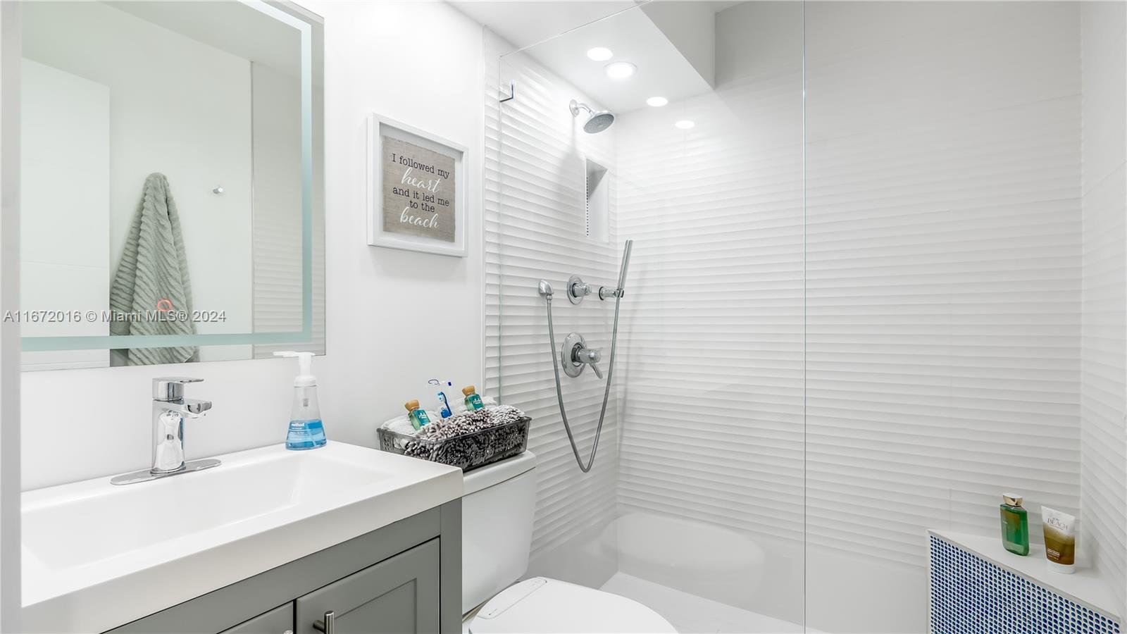 201 Van Buren Street, Unit 103 Hollywood, FL 33019 - Photo 13 of 25 a bathroom with a sink a toilet and shower