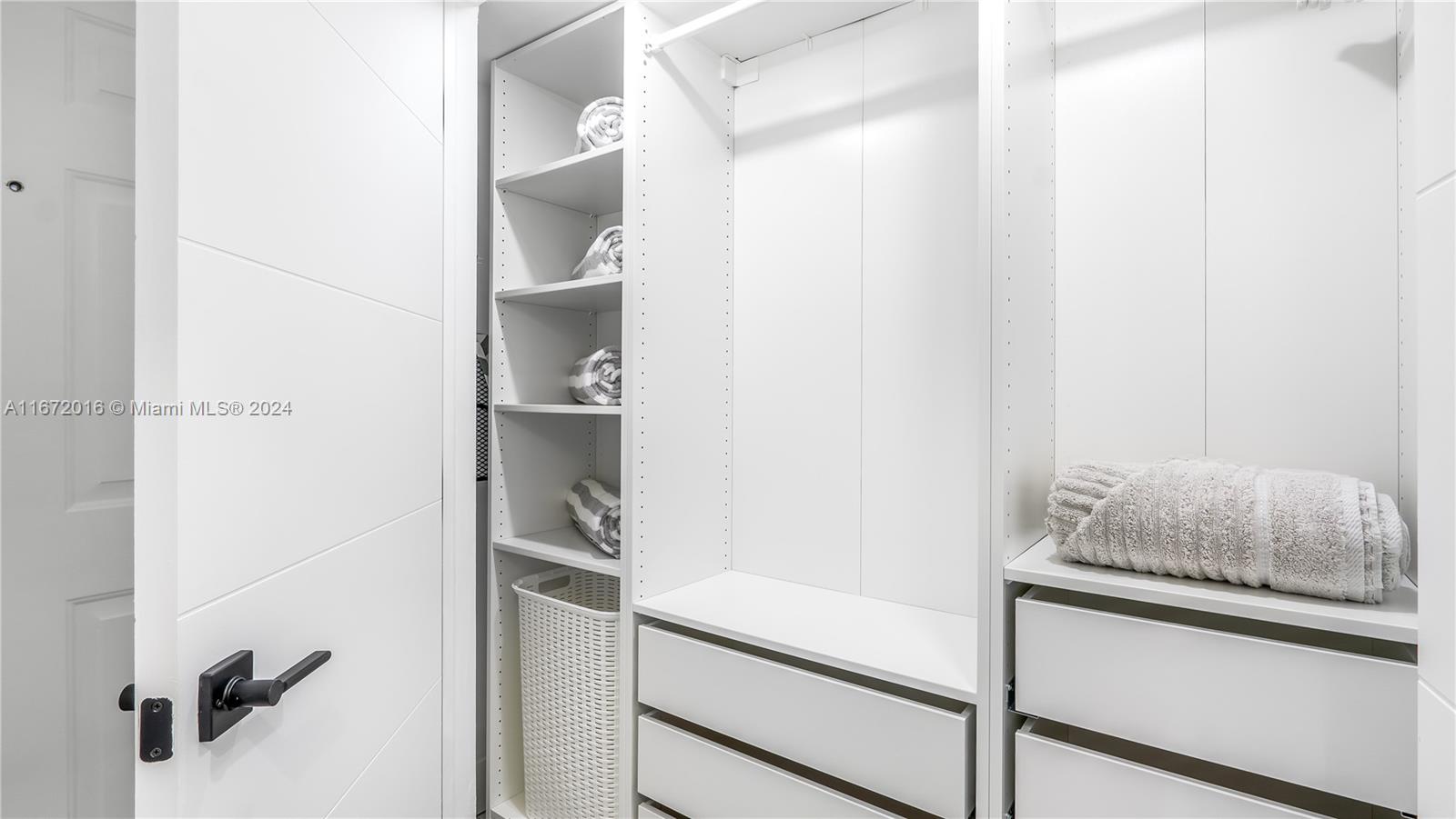 201 Van Buren Street, Unit 103 Hollywood, FL 33019 - Photo 16 of 25 a hallway with white cabinets and wooden floor