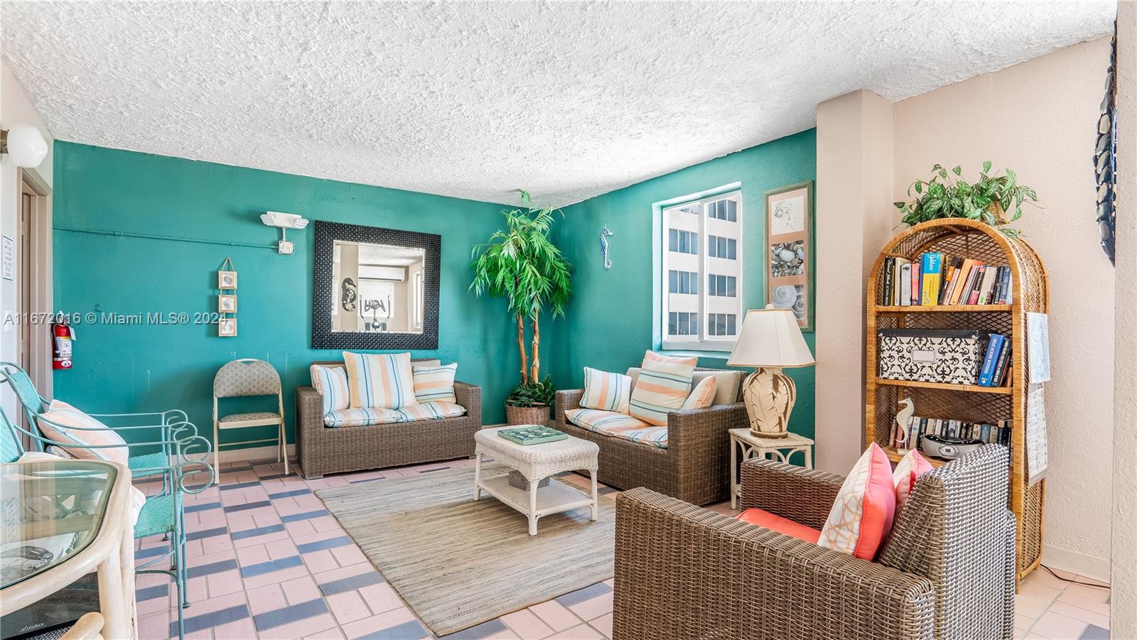 201 Van Buren Street, Unit 103 Hollywood, FL 33019 - Photo 19 of 25 a living room with furniture and a window