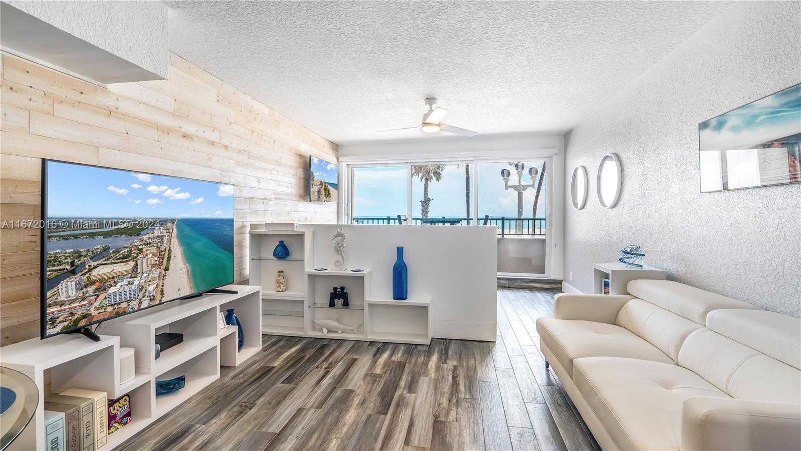 201 Van Buren Street, Unit 103 Hollywood, FL 33019 - Photo 2 of 25 a living room with furniture and a wooden floor