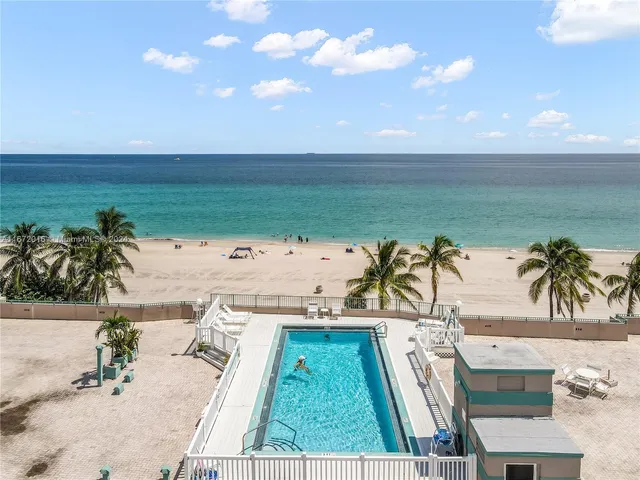 a view of a swimming pool with a lawn chairs