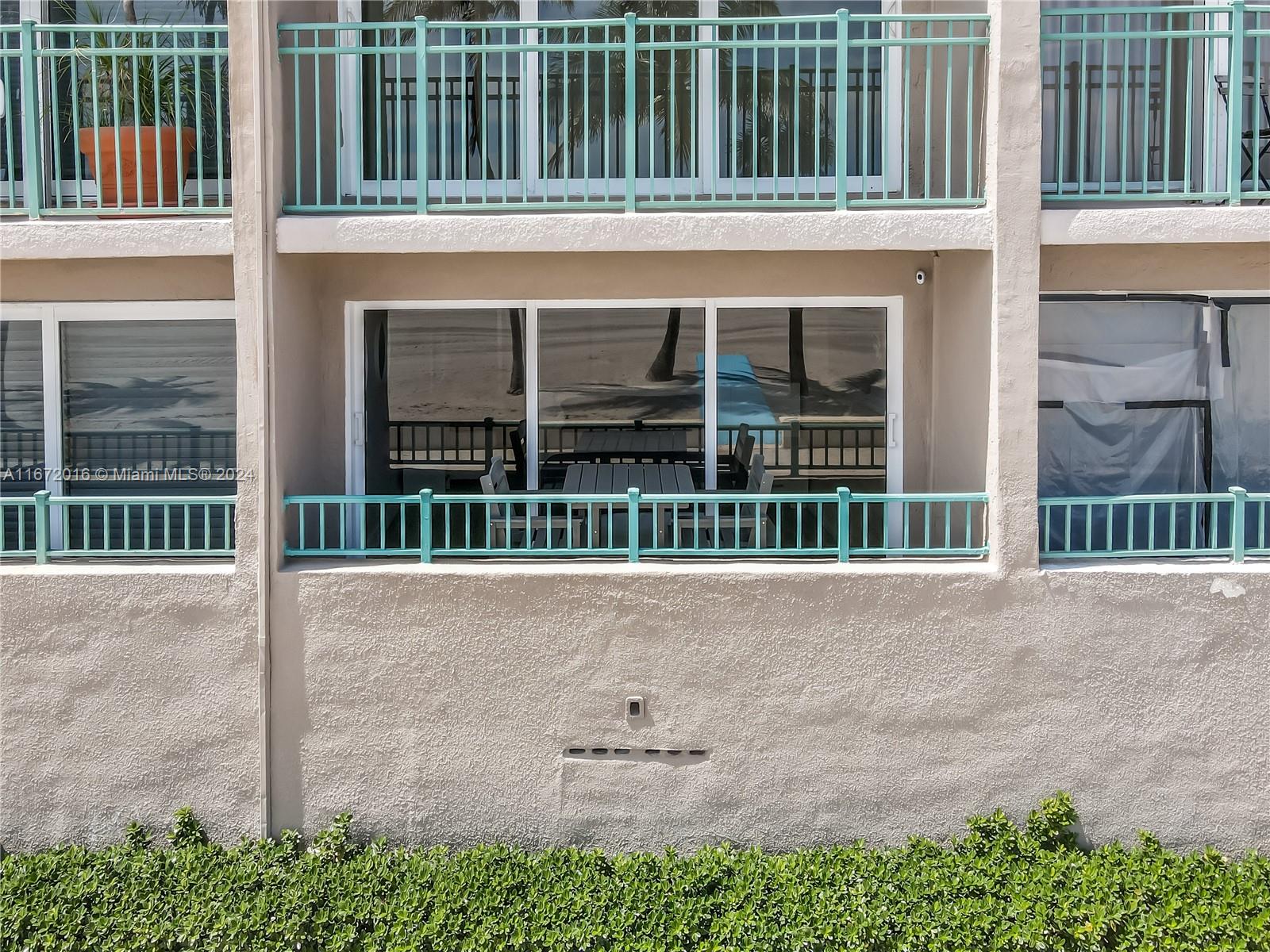 201 Van Buren Street, Unit 103 Hollywood, FL 33019 - Photo 24 of 25 front view of a house with a large window