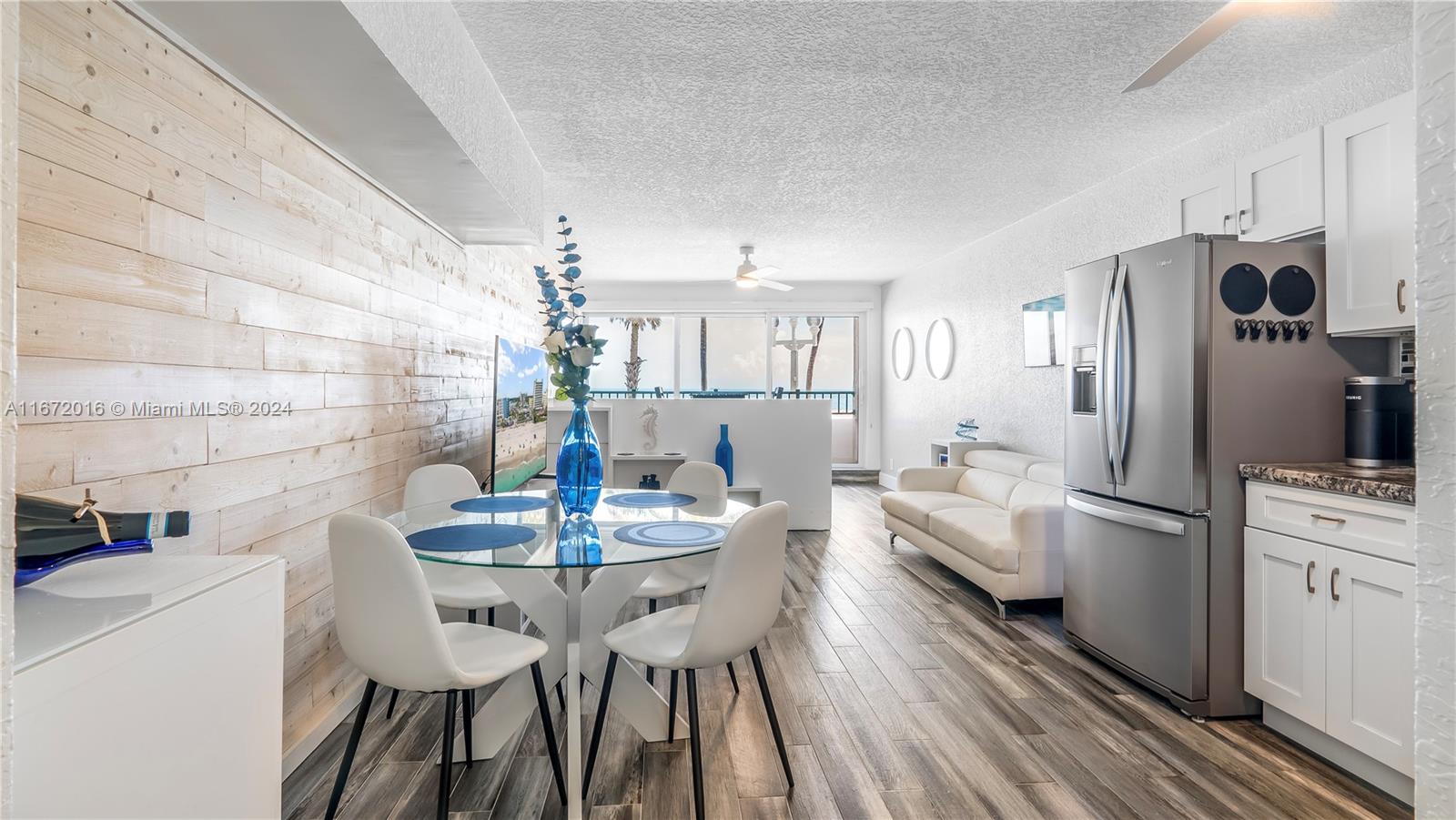 201 Van Buren Street, Unit 103 Hollywood, FL 33019 - Photo 3 of 25 a view of a dining room with furniture and wooden floor