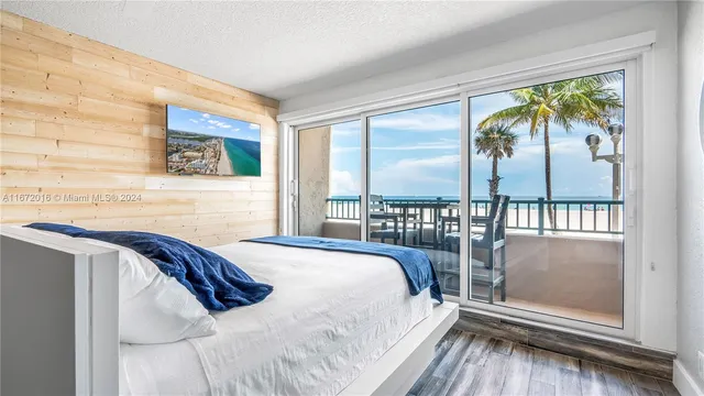 a bedroom with a bed and a balcony