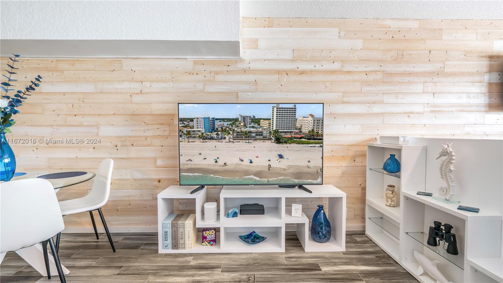 201 Van Buren Street, Unit 103 Hollywood, FL 33019 - Photo 8 of 25 a view of a kitchen with table and chairs