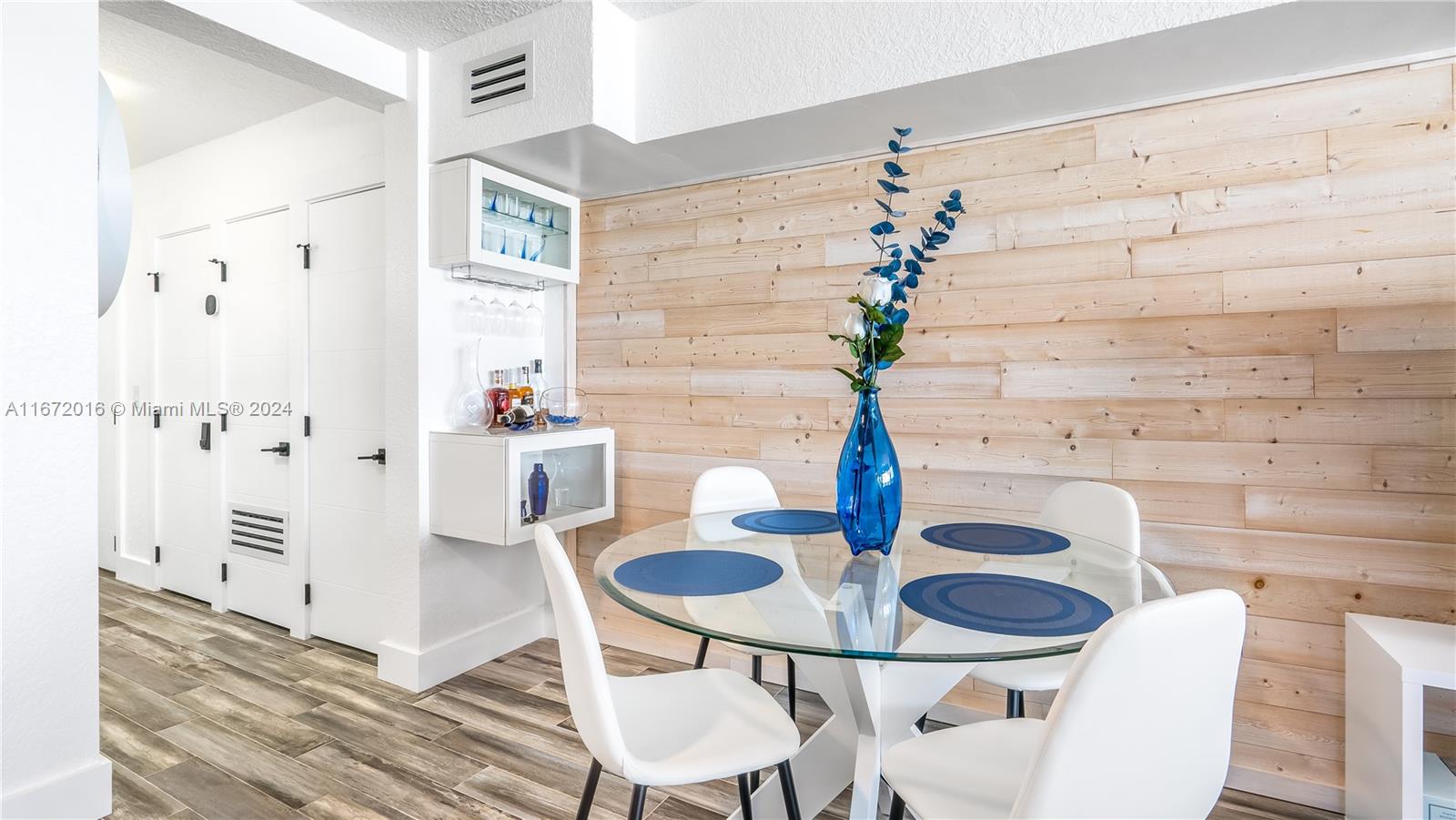 201 Van Buren Street, Unit 103 Hollywood, FL 33019 - Photo 10 of 25 a dining room with furniture and wooden floor