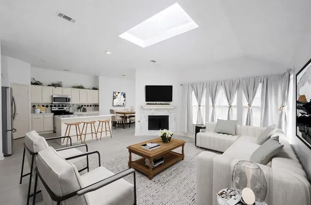 a living room with furniture a flat screen tv and a fireplace