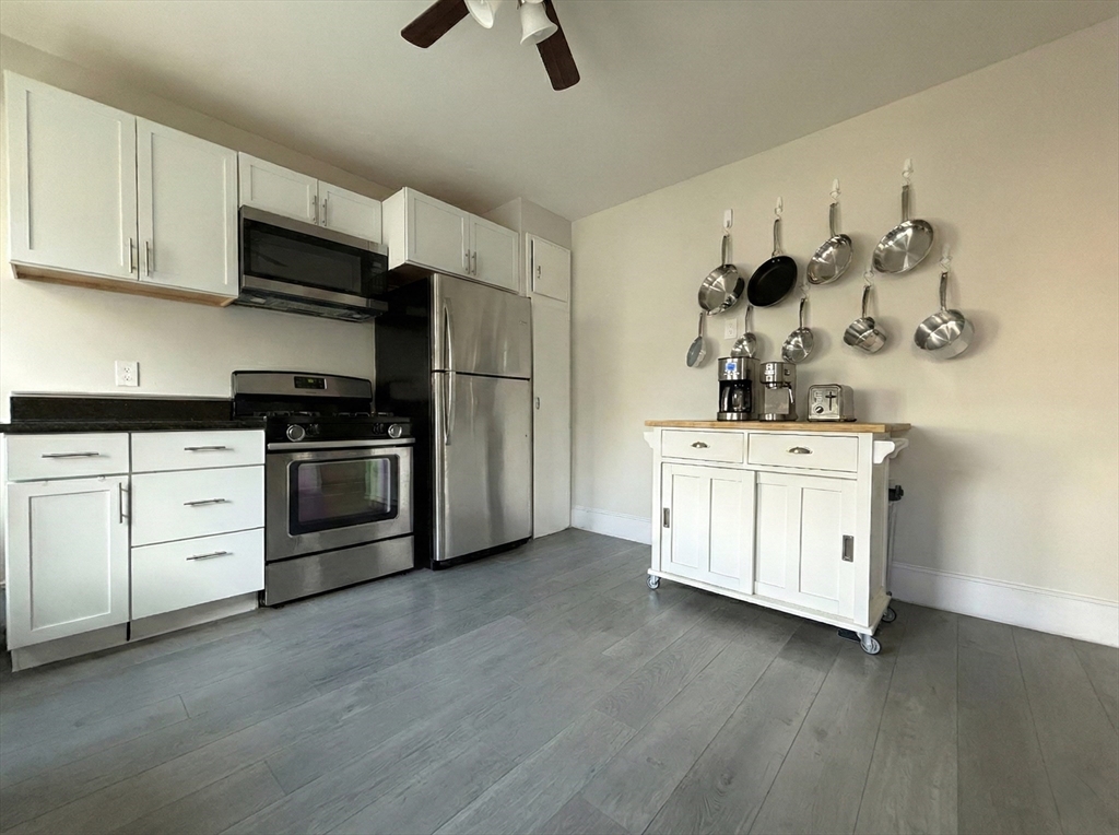 20 Fellsway West, Unit 2 Somerville, MA 02145 - Photo 2 of 16 a kitchen with stainless steel appliances white cabinets and a sink