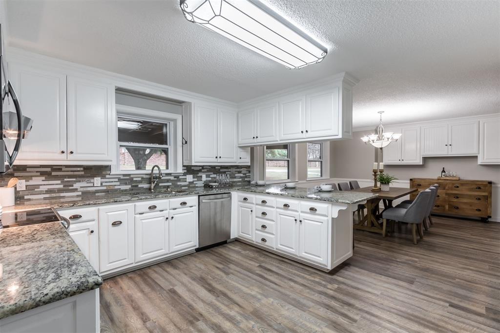5629 West Caylor Road Fort Worth, TX 76244 - Photo 1 of 1 a kitchen with granite countertop sink stove and cabinets