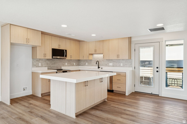 252 North Main Street Bountiful, UT 84010 - Photo 5 of 34 Kitchen with light wood finish cabinets, a kitchen island, stainless steel appliances, light wood-style floors, and recessed lighting